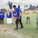 Kapolres Tojo Una-Una AKBP Yanna Djayawidya, S.I.K., M.H., melakukan tendangan bola pertama sebagai tanda resmi dimulainya Turnamen Sepakbola Piala Gubernur “Berani Cup 2026” di Lapangan Stamina Ampana, Jumat (19/6/2026).