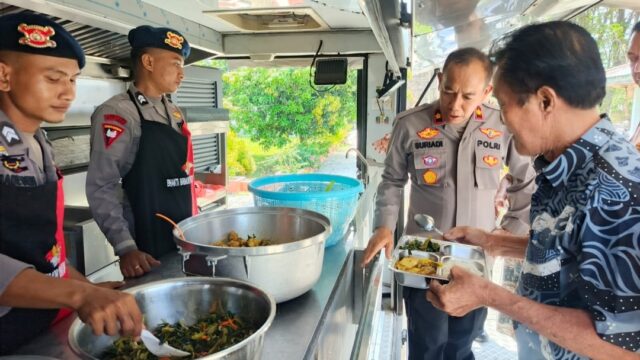 Personel Batalyon B Pelopor Satbrimob Polda Sulawesi Tengah menyalurkan makanan siap santap dari kendaraan dapur lapangan bagi warga terdampak kebakaran di Kelurahan Ranononcu, Kabupaten Poso, Kamis (16/7/2026).