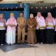 Wakil Bupati Tojo Una-Una Hj. Surya beserta jajaran berfoto bersama para pendidik berprestasi yang menerima penghargaan pada peringatan HUT ke-69 SMP Negeri 1 Ampana Kota, Senin (31/8/2026).