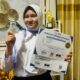 Qisya Zahra Alimun menampilkan medali dan piagam penghargaan yang diraih dalam Festival Sains Digital Nasional (FSDN) 2026, Oktober 2026. Qisya berhasil meraih medali emas bidang IPA dan medali perak bidang Biologi.